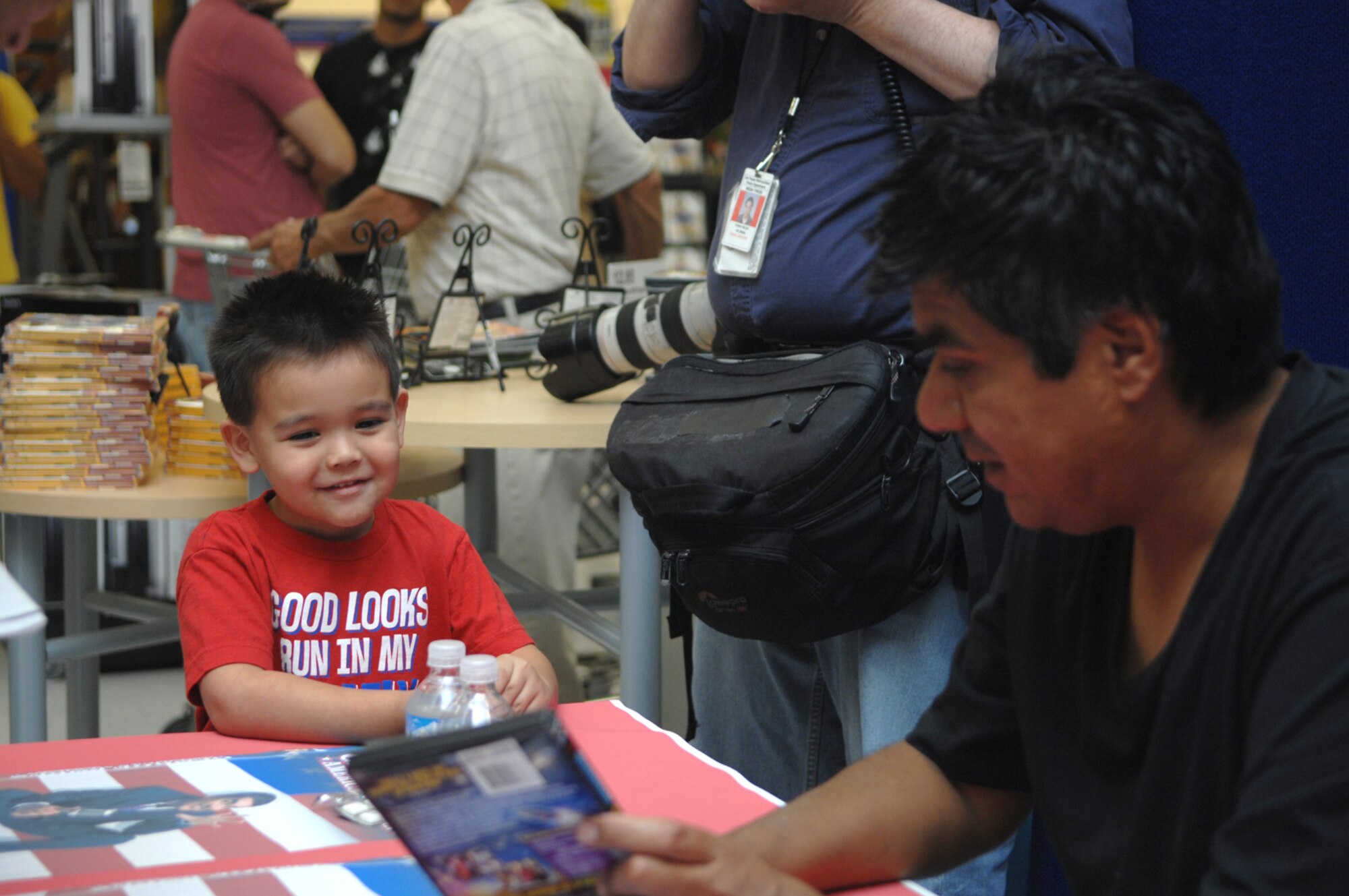 Robert Rodriquez Jr., son of Senior Airman Robert Rodriquez, 57th Aircraft Maintenance Squadron and wife, Tina, gets an autograph from Comedian George Lopez during a Meet and Greet session at the Nellis Air Force Base Exchange August 4, 2007. Mr. Lopez visited Nellis AFB, NV while in Las Vegas to perform for his America’s Mexican Tour at the Las Vegas Hilton Hotel. 
(U.S. Photo by Airman 1st Class Nadine Y. Barclay)(RELEASED)
