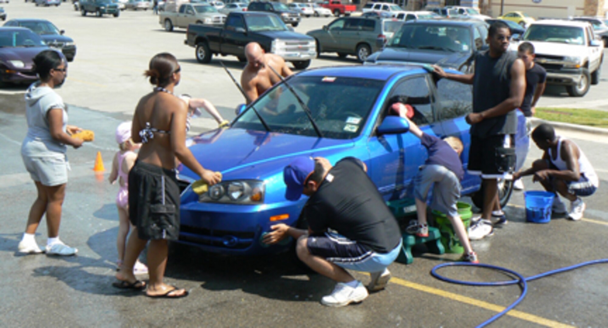 DYESS AIR FORCE BASE, Texas -- Members of Team Dyess and the Dyess We Care Team raised $1,845 washing cars in Abilene Aug. 4. The money benefits the Fort Imagination playground, which was burned by vandals Oct. 4, 2006. This Oct. 4, the money raised by Dyess and the Abilene community will be put back into the playground, repairing $60,000 worth of damage. Last month's WCT car wash fundraiser added an additional $1,590 for the project. (Photo provided by Master Sgt. Gordon Storey)