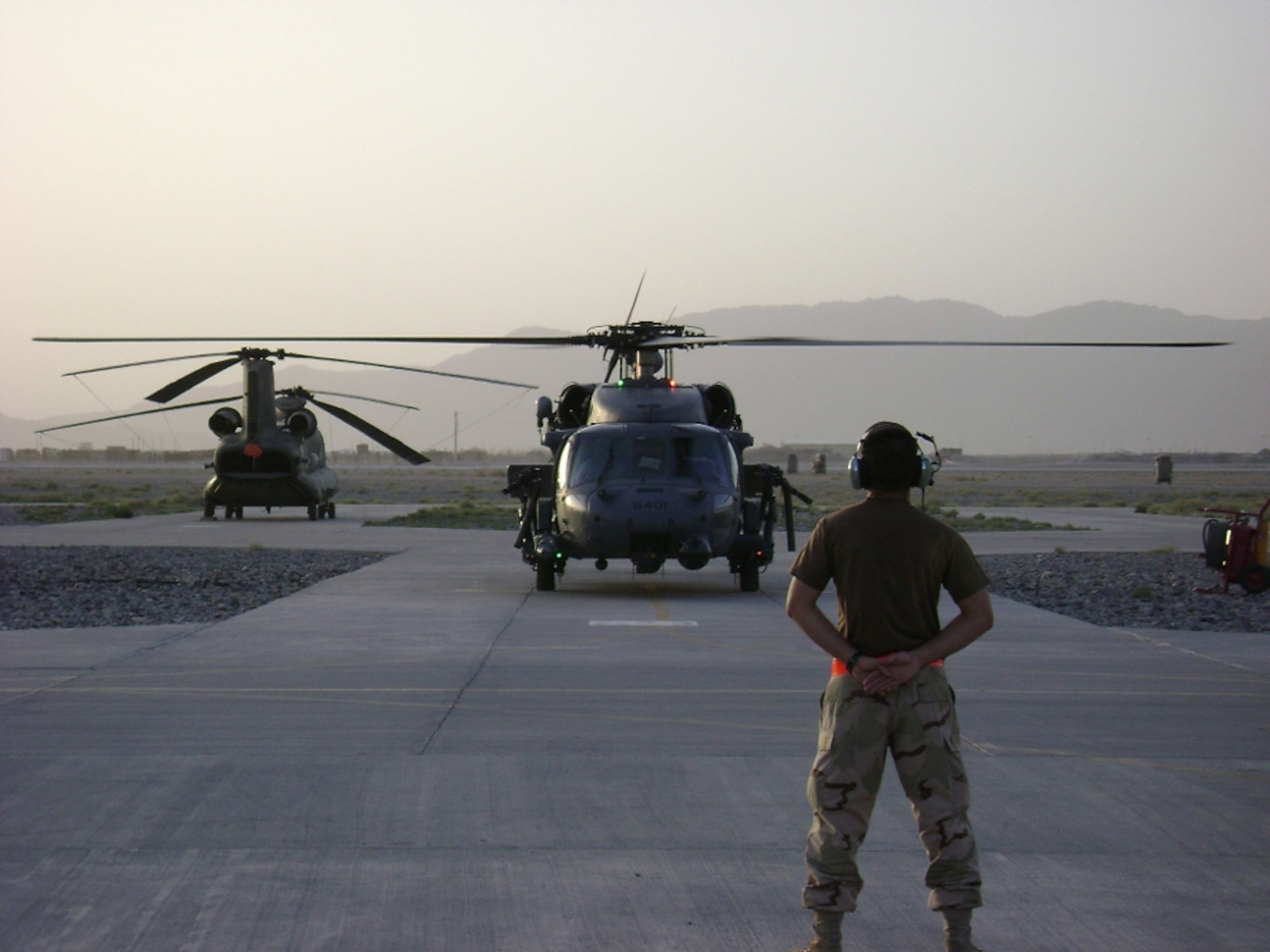 Airman 1st Class Maximino Gonzalez prepares to launch a 33rd Rescue Squadron HH-60 Pave Hawks at Kandahar, Afghanistan.  The 33rd RQS from Kadena Air Base, Japan, deployed the end of July to Kandahar to conduct combat search and rescue and medical rescue missions in support of Operation Enduring Freedom. The squadron headed back to Afghanistan after returning from a four-month deployment to Kandahar in May.  Airman Gonzalez is a crew chief with the 718th Aircraft Maintenance Squadron. U.S. Air Force photo