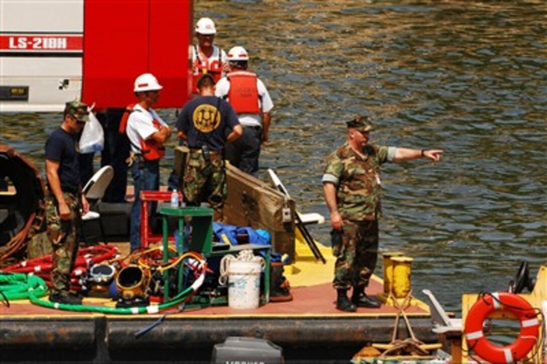 U.S. Navy divers from Mobile Diving and Salvage Unit 2 out of Naval Amphibious Base Little Creek, Va., are working in tandem with the U.S. Army Corps of Engineers to survey and assess the wreckage of the I-35 bridge in Minneapolis. 