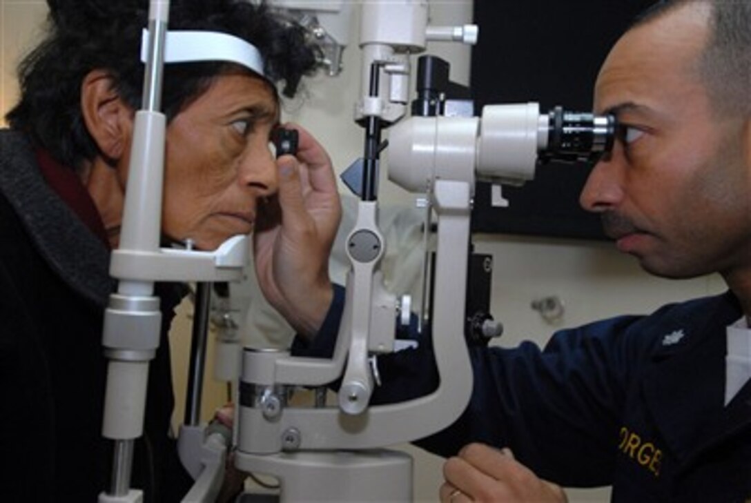 U.S. Navy Ophthalmologist Cmdr. Octavio Borges (right) examines Susana Mendoza, a Peruvian patient, on board the hospital ship USNS Comfort (T-AH 20) off the coast of Peru on Aug. 6, 2007.  The Military Sealift Command hospital ship is on a four-month humanitarian deployment to Latin America and the Caribbean to provide medical treatment to patients from a dozen countries.  