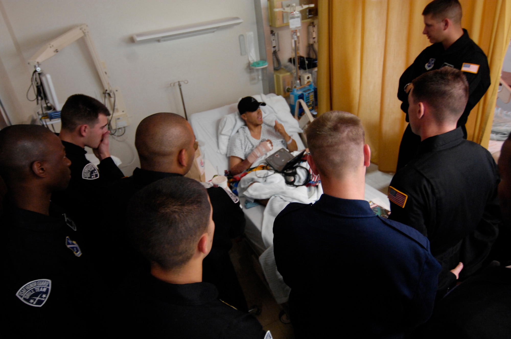 Members of the AF Honor Guard Drill Team speak with an Army soldier who lost his leg and was burned when his convoy was hit with an IED in Baghdad, Iraq a few days prior to his arrival at Landstuhl Regional Medical Center.  The Drill Team performed for, and visited, wounded warriors and the medical center staff on 1 Aug. 2007, during their recent Europe tour. (U.S. Air Force photo by Senior Airman Daniel DeCook)(Released)