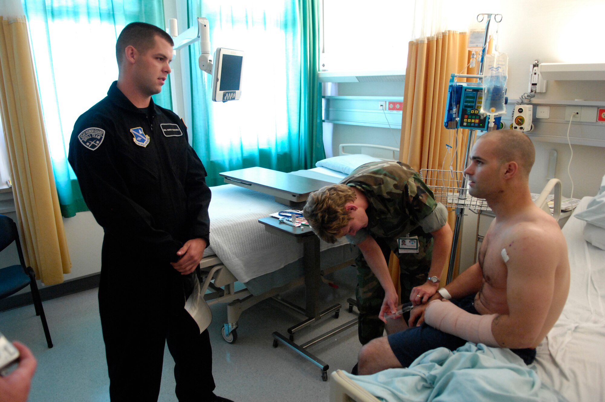 Senior Airman James Cashwell, U.S. Air Force Honor Guard Drill Team, talks with a hometown friend, Army Spc. Matthew Goodwin, after a suprise & chance meeting at Landstuhl Regional Medical Center on 1 Aug. 2007. The Drill Team performed for, and visited, wounded warriors and the medical center staff on 1 Aug. 2007, during their recent Europe tour. (U.S. Air Force photo by Senior Airman Daniel DeCook)(Released)