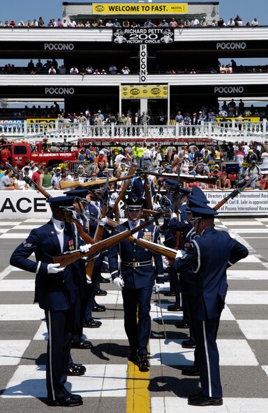 The United States Air Force Honor Guard Drill Team performs their famous 'gauntlet walk-through' displaying Air Force precision to a crowd of 80K, including Gen Peter Pace, the Chairman of the Joint Chiefs of Staff, at the Pocono Motor Raceway in Pocono, PA, Aug. 5, 2007.  Pocono Motor Raceway is the first stop for the Drill Team on their Northeast Tour to promote the Air Force mission, showcasing drill performances at public and military venues to recruit, retain, and inspire Airmen. (U.S. Air Force photo by Airman First Class Marleah Miller)(Released)