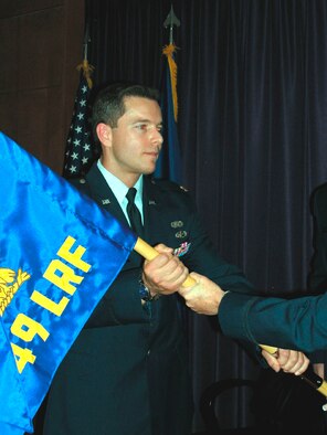 Major Roderick T. Grunwald receives the 349th Logistics Readiness Flight unit flag as he assumes command in a ceremony held at Travis Air Force Base Aug. 4. (U.S. Air Force photo by Staff Sgt. Meredith Mingledorff)