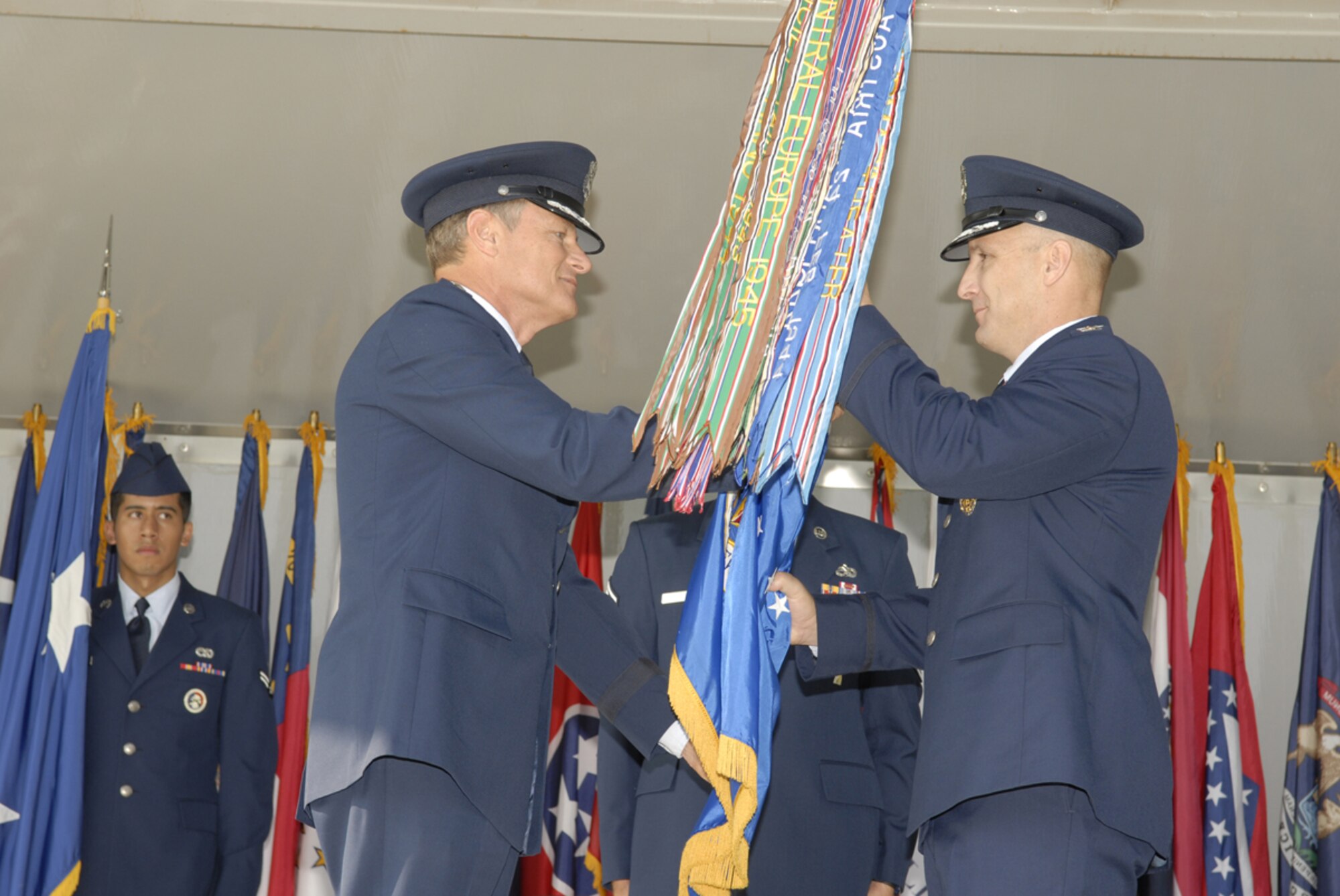 Maj. Gen. Irving L. Halter Jr. (left), Commander, 19th Air Force, handed command of the 97th Air Mobility Wing to Col. David W. Allvin during a 97th AMW change of command ceremony Aug. 3 on the Parade Grounds here. (U.S. Air Force photo/Senior Airman Joshua Demotts)