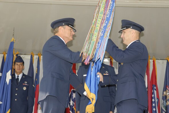Maj. Gen. Irving L. Halter Jr. (left), Commander, 19th Air Force, handed command of the 97th Air Mobility Wing to Col. David W. Allvin during a 97th AMW change of command ceremony Aug. 3 on the Parade Grounds here. (U.S. Air Force photo/Senior Airman Joshua Demotts)
