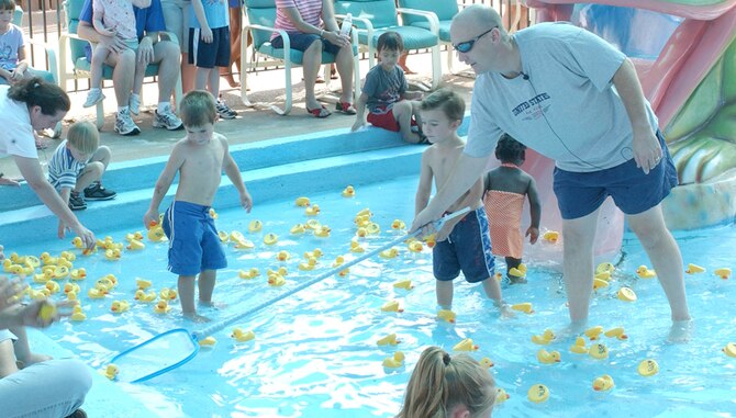 Col. David Allvin, 97th Air Mobility Wing commander, nets a winning duckling in Saturday’s Duck Derby fund raiser for the Altus AFB Youth Center. (U.S. Air Force photo/Michael Fletcher)