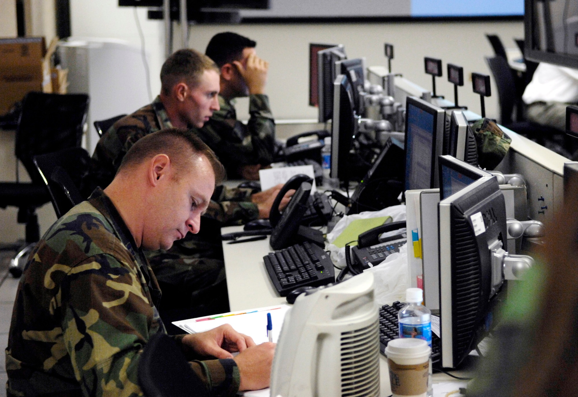 Members of the intelligence, surveillance and reconnaissance division provide intel to the chief of operations during Exercise Valiant Shield Aug. 7 in the Air and Space Operation Center at Hickam Air Force Base, Hawaii. The Airmen are from the 613th Air Operations Center. Valiant Shield is a week-long exercise that tests the military's ability to rapidly consolidate joint forces in response to regional contingencies, involves approximately 22,000 troops, 30 ships and some 275 aircraft. (U.S. Air Force photo/Tech. Sgt. Shane A. Cuomo) 
