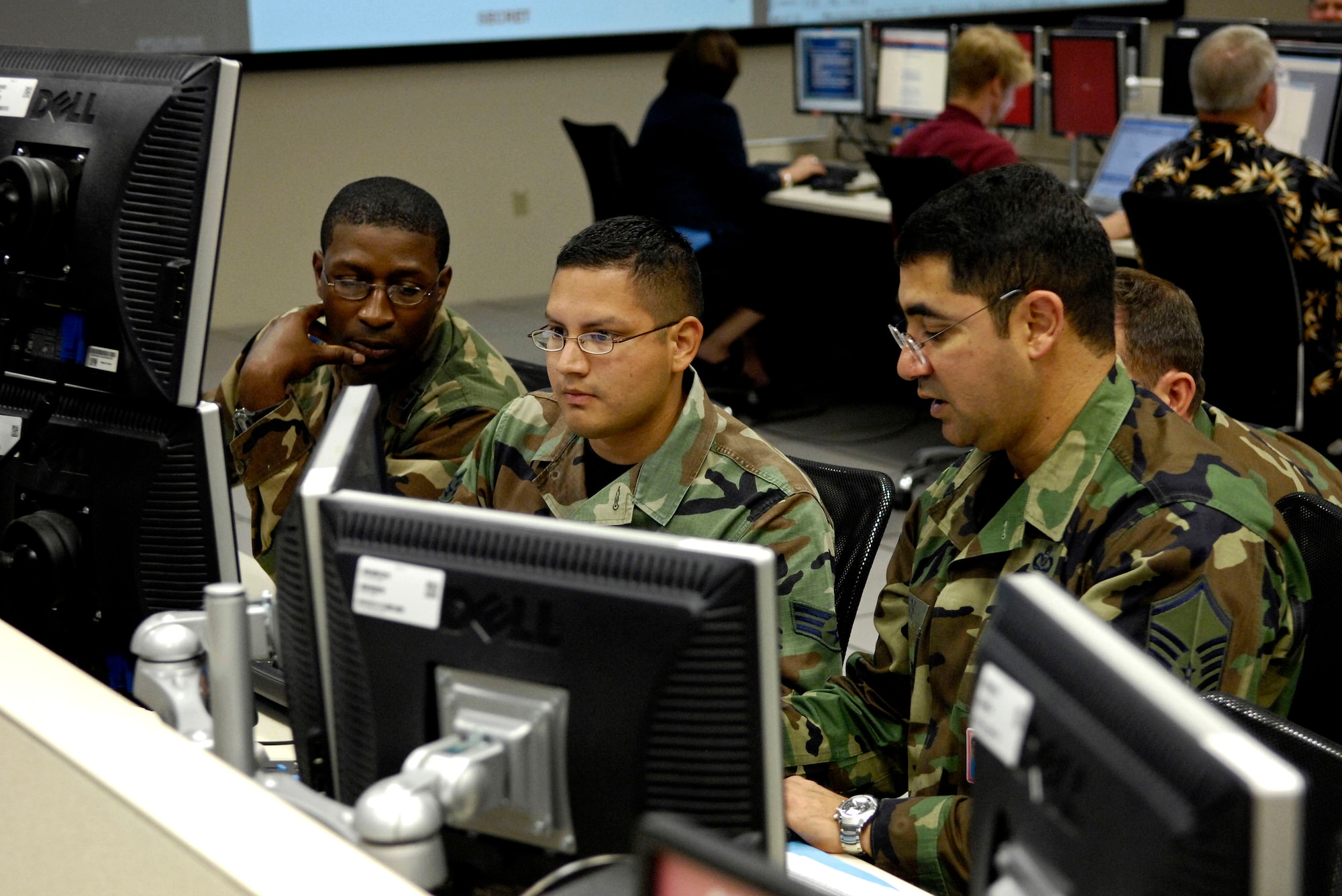 Members of the personnel recovery coordination cell discuss a downed pilot recovery mission during Exercise Valiant Shield Aug. 7 in the Air and Space Operation Center at Hickam Air Force Base, Hawaii. The Airmen are from the 613th Air Operations Center. Valiant Shield is a week-long exercise that tests the military's ability to rapidly consolidate joint forces in response to regional contingencies, involves approximately 22,000 troops, 30 ships and some 275 aircraft. (U.S. Air Force photo/Tech. Sgt. Shane A. Cuomo) 
