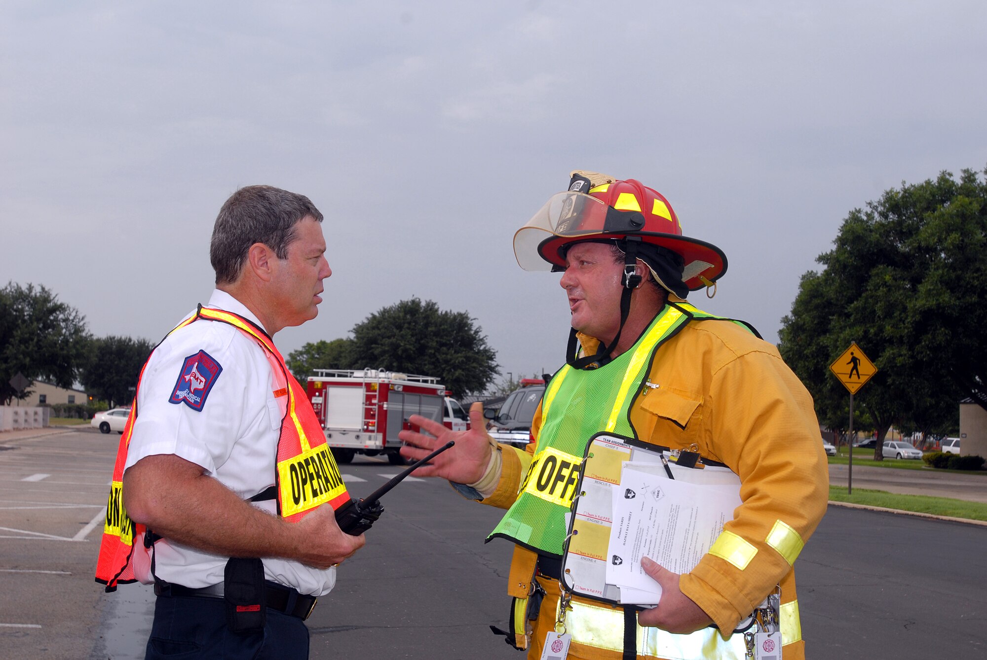 Jeff Wilkins (left), deputy chief with the Goodfellow Fire Department, discusses strategy with Gene Crabtree, also of the Goodfellow Fire Department, during the base-wide disaster exercise Aug. 2. (U.S. Air Force photo by Tech. Sgt. Gina O’Bryan)