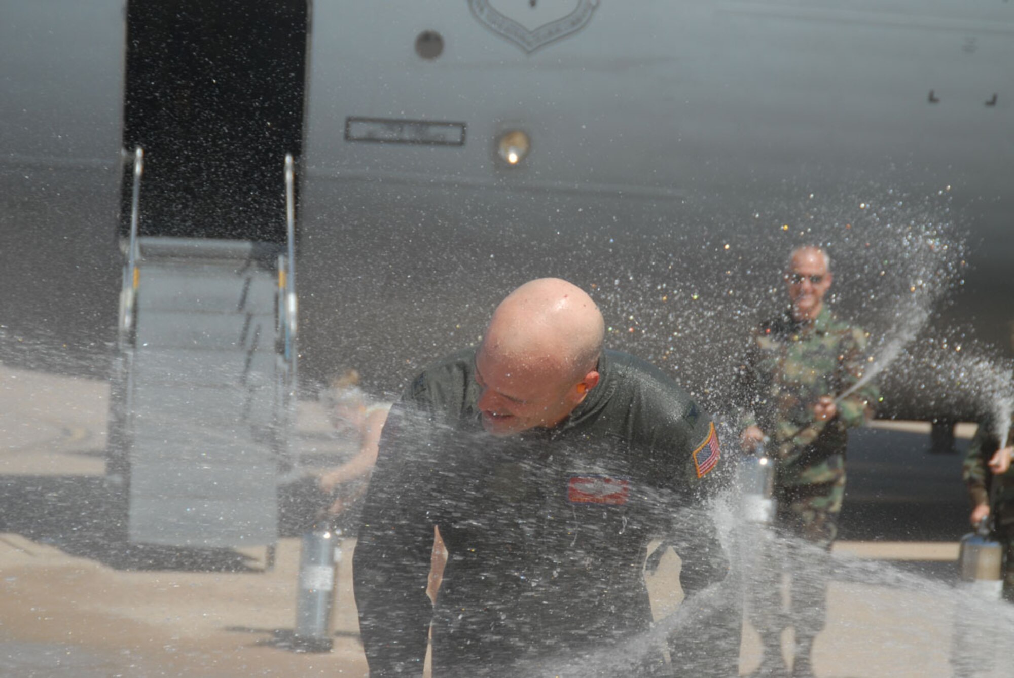 Col. Carlton D. Everhart II, 97th Air Mobility Wing commander, gets a final soaking from family and friends after flying his last sortie as 97th AMW commander. Col. Everhart will be moving on to serve as Air Education and Training Command’s Inspector General at Randolph Air Force Base.