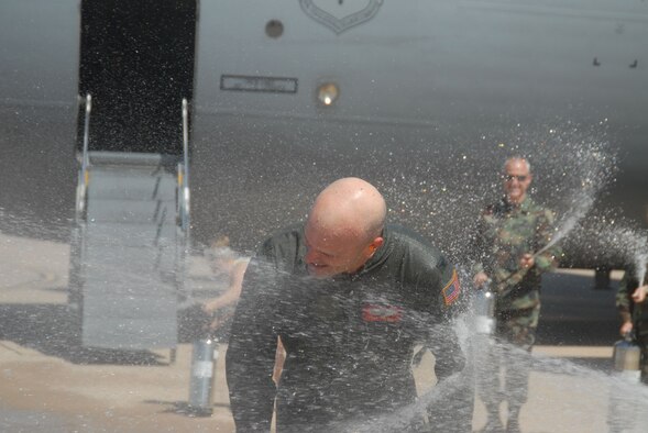 Col. Carlton D. Everhart II, 97th Air Mobility Wing commander, gets a final soaking from family and friends after flying his last sortie as 97th AMW commander. Col. Everhart will be moving on to serve as Air Education and Training Command’s Inspector General at Randolph Air Force Base.