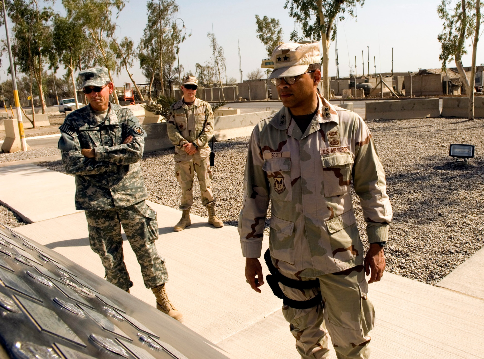 Maj. Gen. Darryl A. Scott looks over the 332nd Air Expeditionary Wing's Fallen Airman Memorial along with Army Col. Anthony Helm and Staff Sgt. Mike Shellhaas July 31 at Balad Air Base, Iraq. General Scott is the commander of the Joint Contracting Command Iraq/Afghanistan. Colonel Helm is assigned to the JCC-I/A staff member and Sergeant Shellhaas is assigned to the 332nd AEW Protocol Airman. General Scott is the son of a Tuskegee Airman and took the opportunity to speak about his heritage with Balad AB Airmen. (U.S. Air Force photo/Tech. Sgt. Alan Port)