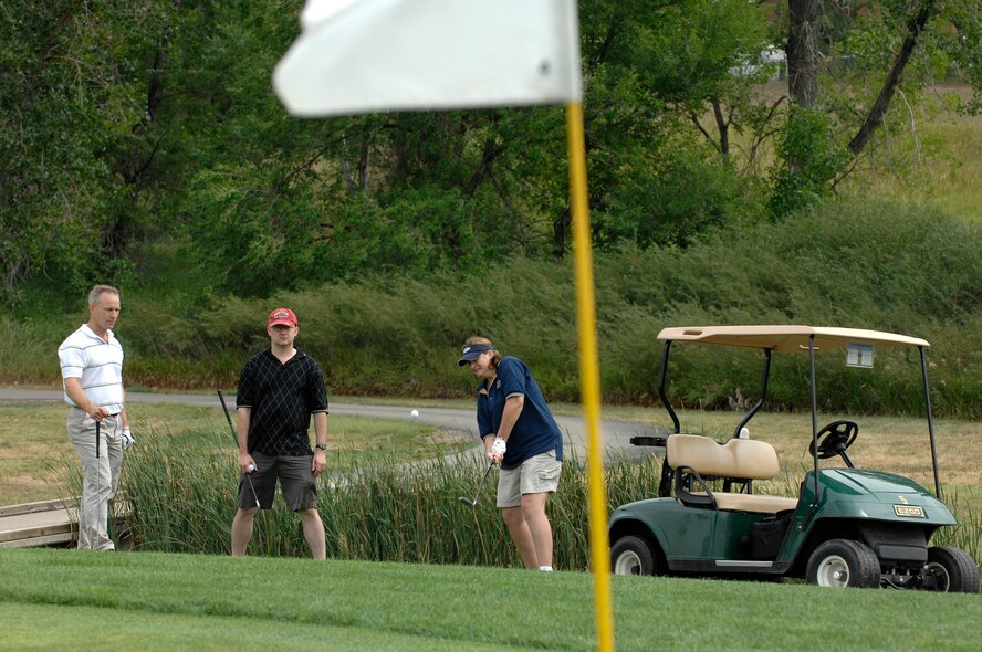 U.S. Air Force Major Marlys May, First Lieutenant Darrin Eckles, and Captain Christopher Maxey, right to left from the 28th Communications Squadron, participate in the 28th Bomb Wing First Sergeants Association annual golf tournament at Ellsworth Air Force Base, S.D., Aug. 3, 2007.  The tournament raised $1,700 which will be used for various Ellsworth enlisted functions, awards, and charities.  (U.S. Air Force photo by SSgt Michael B. Keller)(Released)