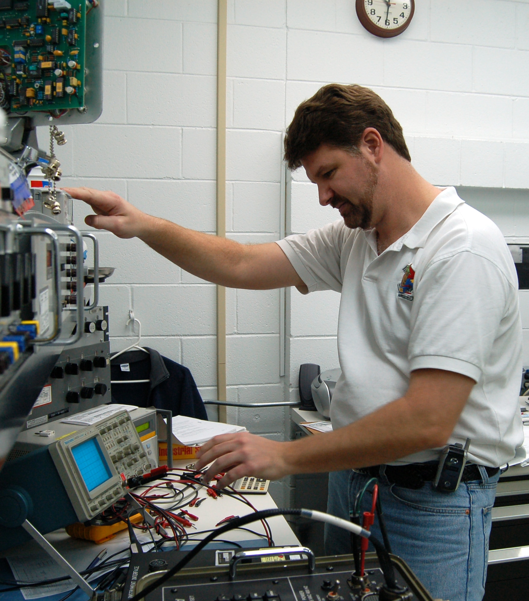 Mike Poole, a technician at Dover AFB Precision Measurement Equipment Laboratory, uses an oscilloscope to verify signal waveforms during a test set calibration. The retired Air Force master sergeant, who hails from Erie, Penn., has worked in PMEL for the past 17 years.  (Photo by Tech. Sgt. Kevin Wallace)