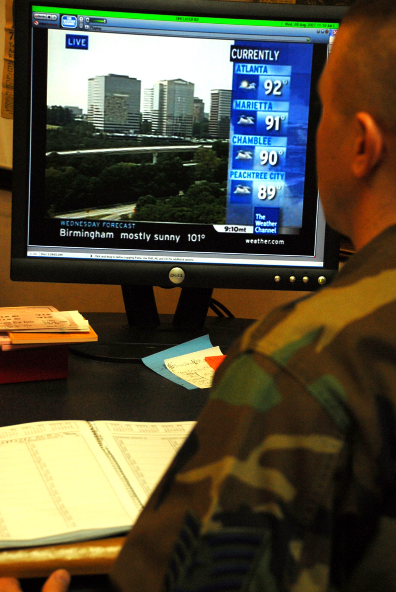 Tech. Sgt. Kevin Wallace checks morning updates on the Weather Channel and receives training videos on his desktop computer using an online video system. (U.S. Air Force photo/ Master Sgt. Joe Springfield)