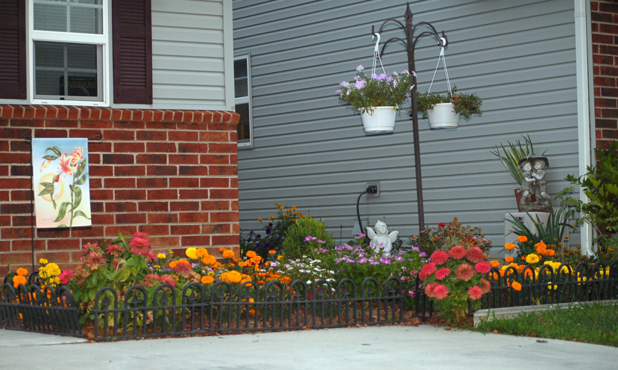 Stone statues and colorful flower arrangements highlight these yards. The combined efforts of Tech. Sgt. Rendy Ricafrente and wife Maria, and Master Sgt. Timothy Ebert and wife Katie keep their common yard elegant. (U.S. Air Force photo/Tech Sgt. Kevin Wallace)
