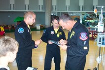 Members of the Viper West demonstration team, based with the 4th Fighter Squadron at Hill Air Force Base, sign autographs for kids at Shriners Hospital in Salt Lake City, Utah.