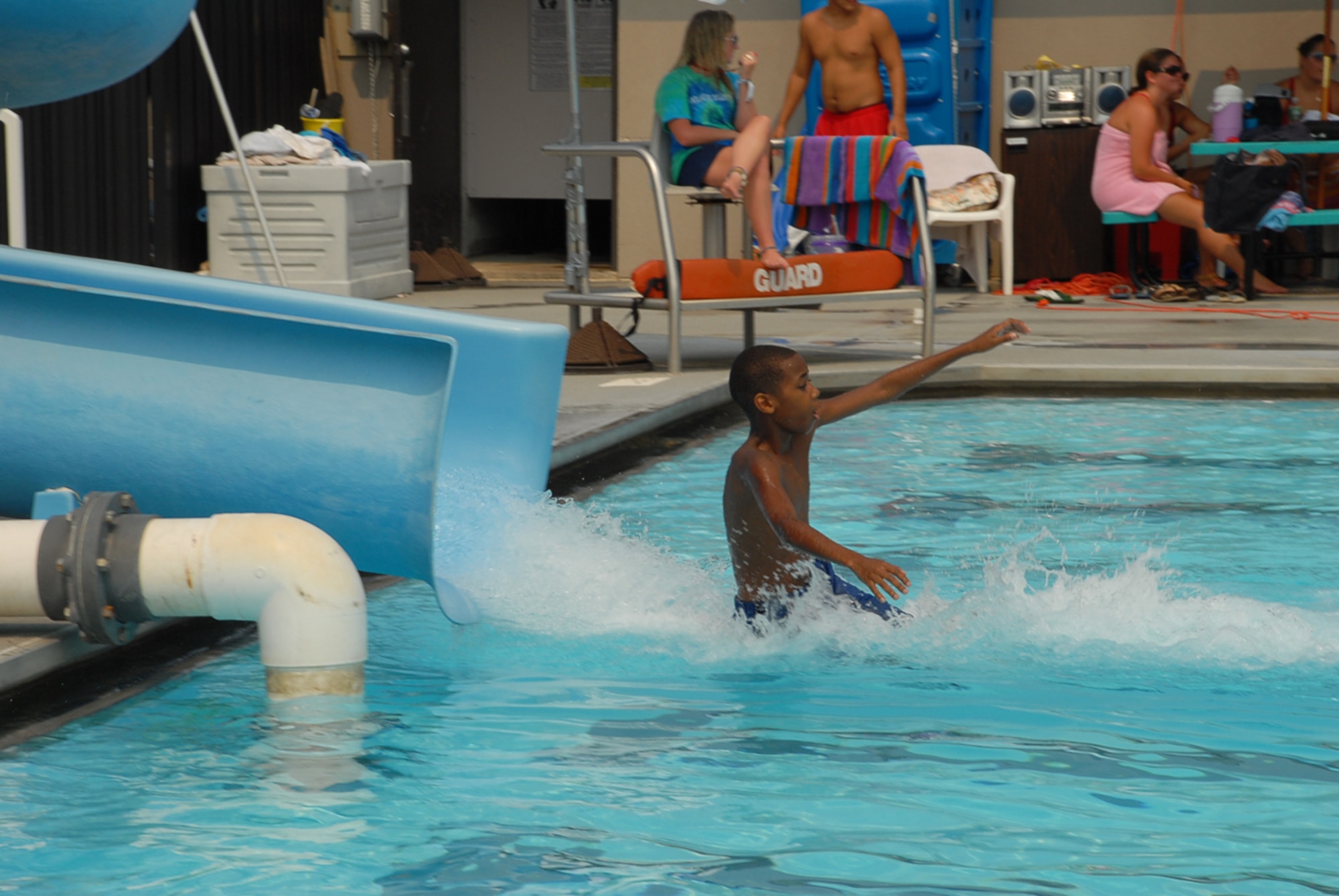 Juwan Gray, son of Master Sgt. Winfert Gray, 436th Medical Group first sergeant, slides feet first into the pool. The first sergeants’ pool party attracted 400 Airmen and family members. (U.S. Air Force photo/Tech. Sgt. Kevin Wallace)