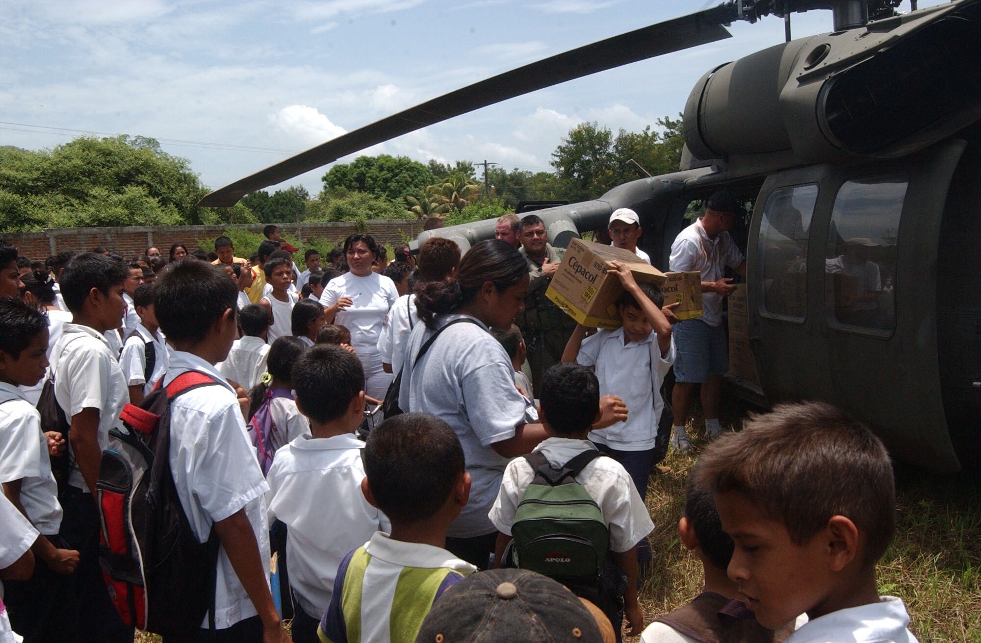 Members of the community help Joint Task Force-Bravo and Naval personnel unload humanitarian supplies during Project Handclasp. Project Handclasp is a partnership between the Navy and corporations, public service organizations, non-government organizations and individuals throughout the United States that provide humanitarian assistance overseas. Members of Joint Task Force-Bravo assisted the Navy with logisitics, ground and air support. Air Force photo by Senior Airman Shaun Emery.                                                         