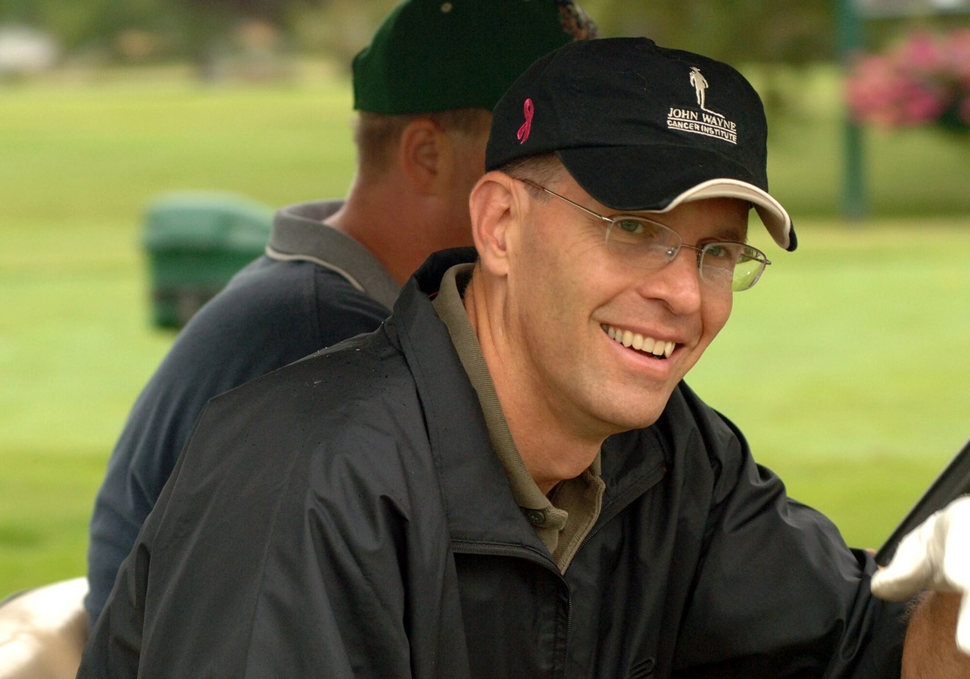 GRAND FORKS AIR FORCE BASE, N.D. -- Col. Bobby Fowler, 319th Operations Group commander, grins encouragingly to his teammate during the annual Grand Forks Military Appreciation Committee golf tournament. Teams comprised of both military and civilian leaders, spent the morning of Aug. 6 in friendly competition including longest drive, longest putt and closest to the hole contests. (U.S. Air Force photo/Senior Airman SerMae Lampkin)