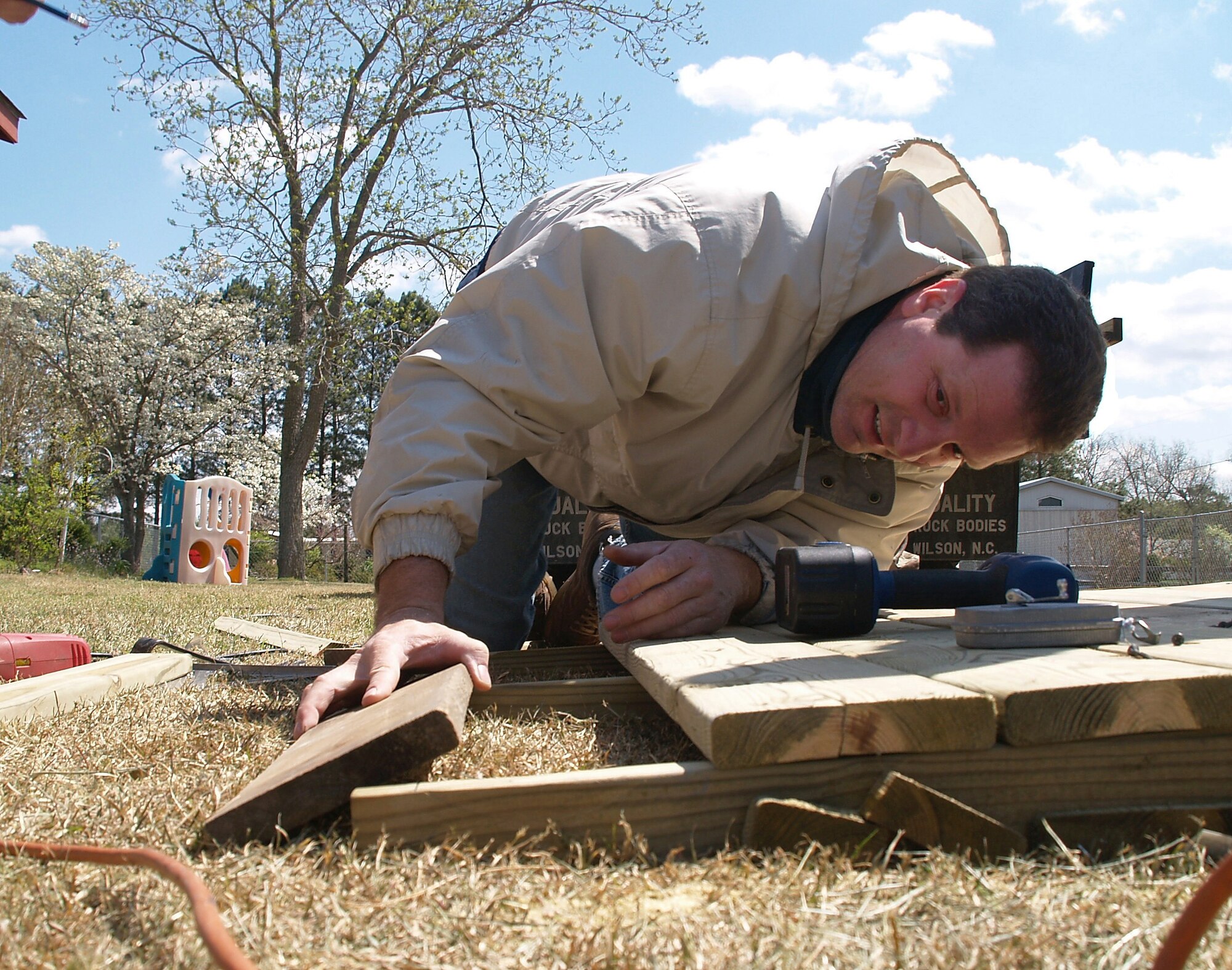 SEYMOUR JOHNSON AIR FORCE BASE, N.C. -- Ramps are not hard to build, but the boards must be just right.  Senior Master Sgt Adrian Darby slides in the next board for a ramp that was used by Master Sgt.. Chris Scher's wife on her return home from the hospital.  Sergeant Darby is a quality assurance superintendent and Sergeant  Scher is quality assurance aircraft inspector.  They both work with the 916th Maintenance Operations Flight, Air Force Reserve.