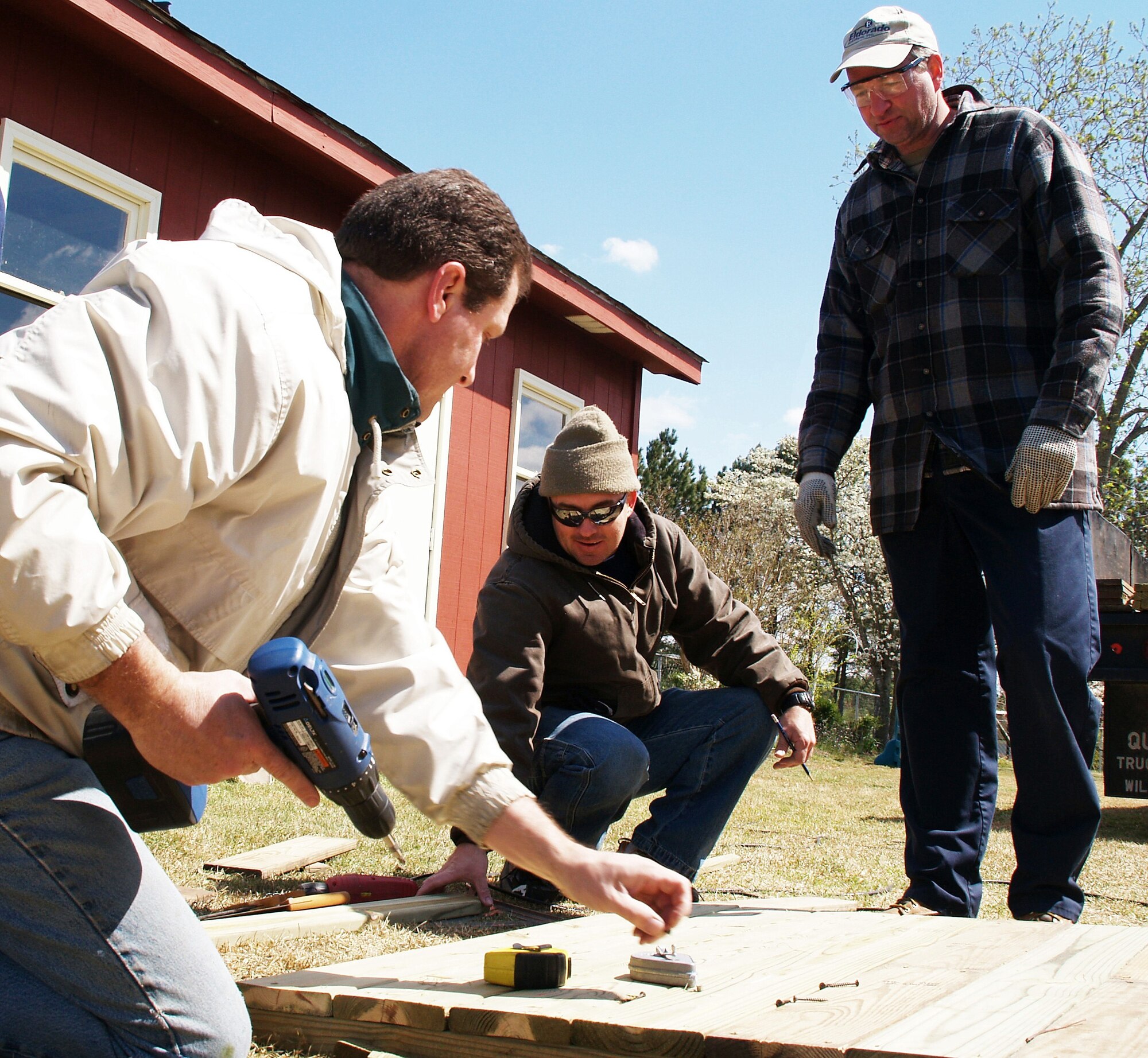 SEYMOUR JOHNSON AIR FORCE BASE, N.C. -- On a cold and frosty Saturday morning, (left to right) Senior Master Sgt. Adrian Darby and Tech Sgts. Jeff Verrett and Mike Marshall took time out to build a ramp for Master Sgt. Chris Scher's wife before returning home from the hospital.  All three reservists work for the 916th Maintenance Operations Flight as quality assurance inspectors.