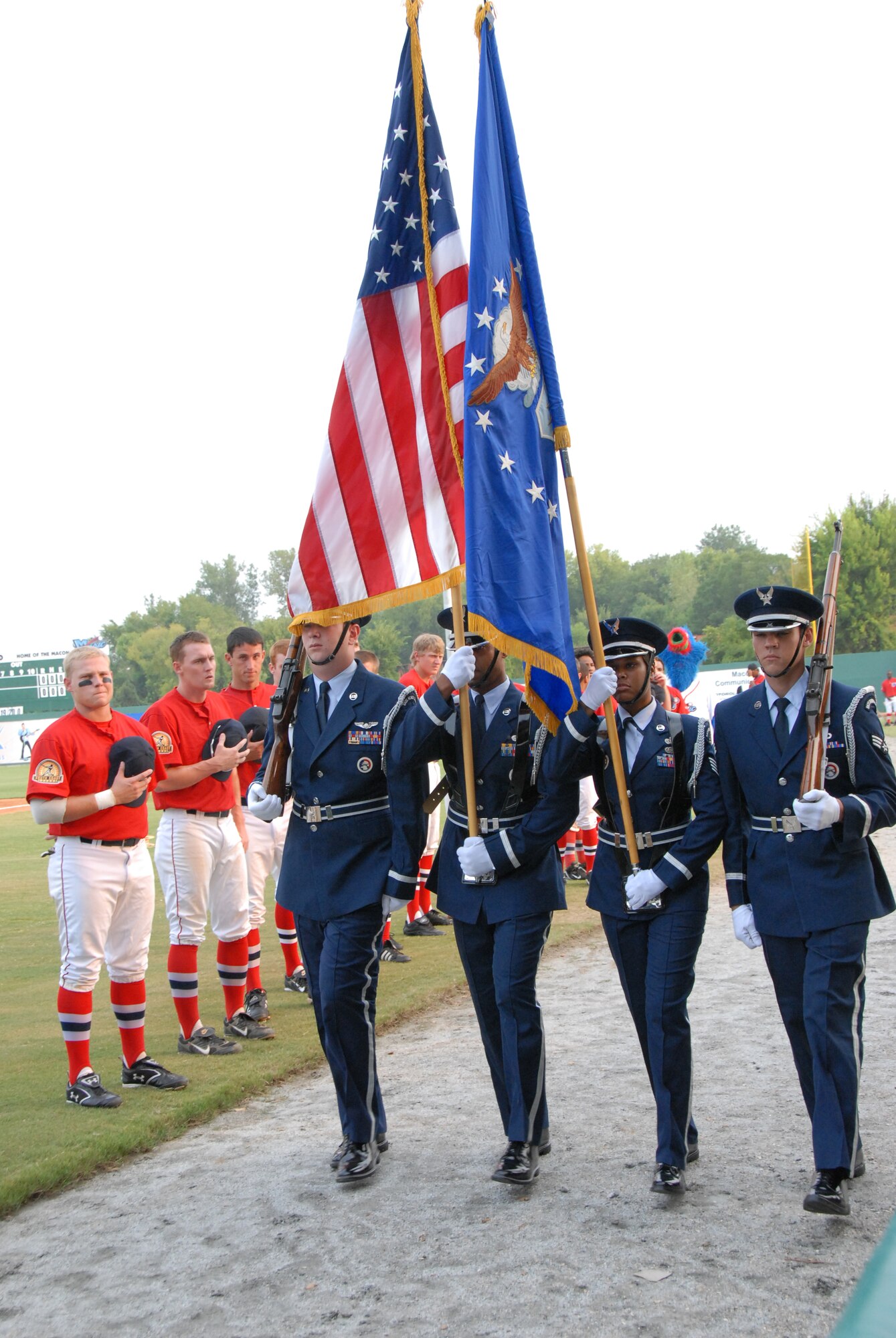 SrA David Stelick, TSgt. Eric Smith, SSgt. Nicole Perry and SrA Nathaniel Miller, Robins's Honor Guard present the colors during pre-game ceremonies at Military Night at the Macon Music game Monday night. U. S. Air Force photo by Sue Sapp