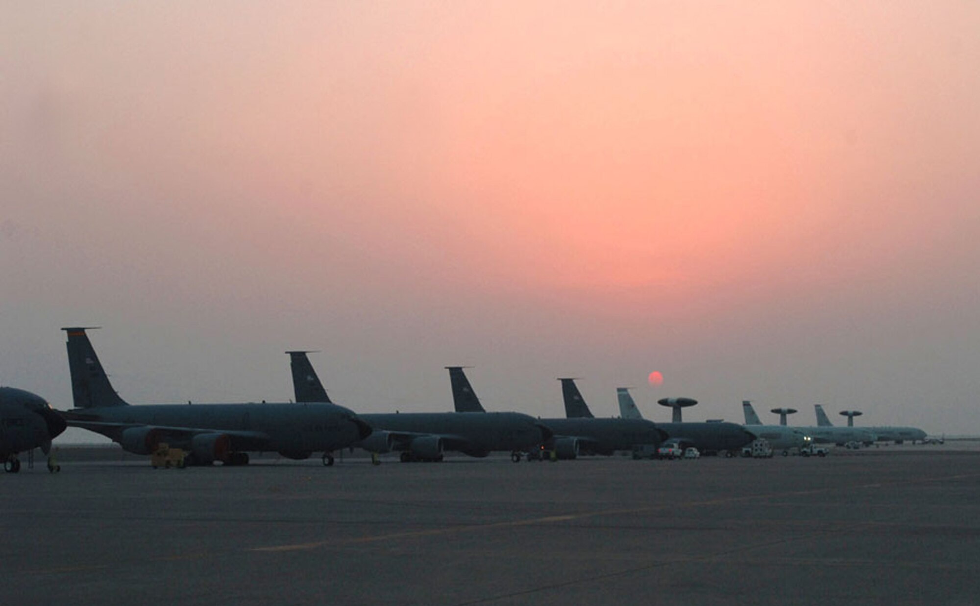 KC-135 Stratotankers and E-3 Sentry airborne warning and control system aircraft await their next missions on the ramp at a deployed location in Southwest Asia.  (U.S. Air Force photo/Staff Sgt. Cassandra Locke)