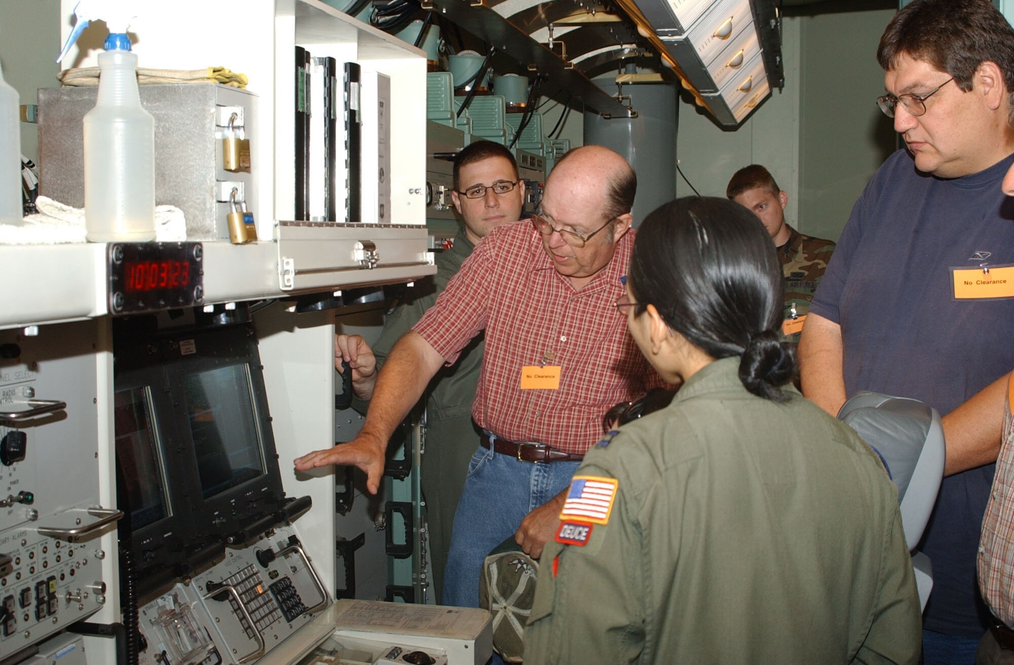 Curt Backa, Great Falls Tribune copy editor, center, asks questions about the missile procedures trainer during his visit to Malmstrom Aug. 8. The Tribune staff were given a mission briefing from wing leadership, did some hands on weapon safety training and also toured a missile maintenance facility.  (U.S. Air Force photo/Senior Airman Eydie Sakura).      