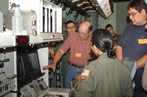 Curt Backa, Great Falls Tribune copy editor, center, asks questions about the missile procedures trainer during his visit to Malmstrom Aug. 8. The Tribune staff were given a mission briefing from wing leadership, did some hands on weapon safety training and also toured a missile maintenance facility.  (U.S. Air Force photo/Senior Airman Eydie Sakura).      