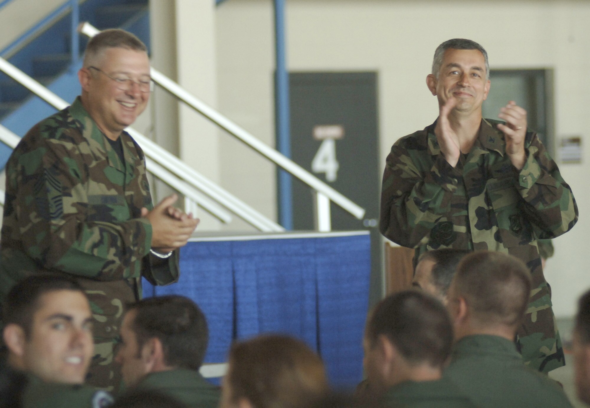 FAIRCHILD AIR FORCE BASE, Wash. – Chief Master Sgt. Paul Sikora, 92nd Air Refueling Wing command chief, and Col. Roger Watkins, 92nd ARW vice commander, applaud top performers during the Unit Compliance Inspection out-brief here Aug. 8. The wing received a rating of Excellent on the inspection, held July 28-31. Thirty seven Team Fairchild members were personally recognized as top performers; 21 of those people were coined by Brig. Gen. Donald Lustig, Air Mobility Command Inspector General, for their exceptional performance. (U.S. Air Force photo/Senior Airman Chad Watkins)