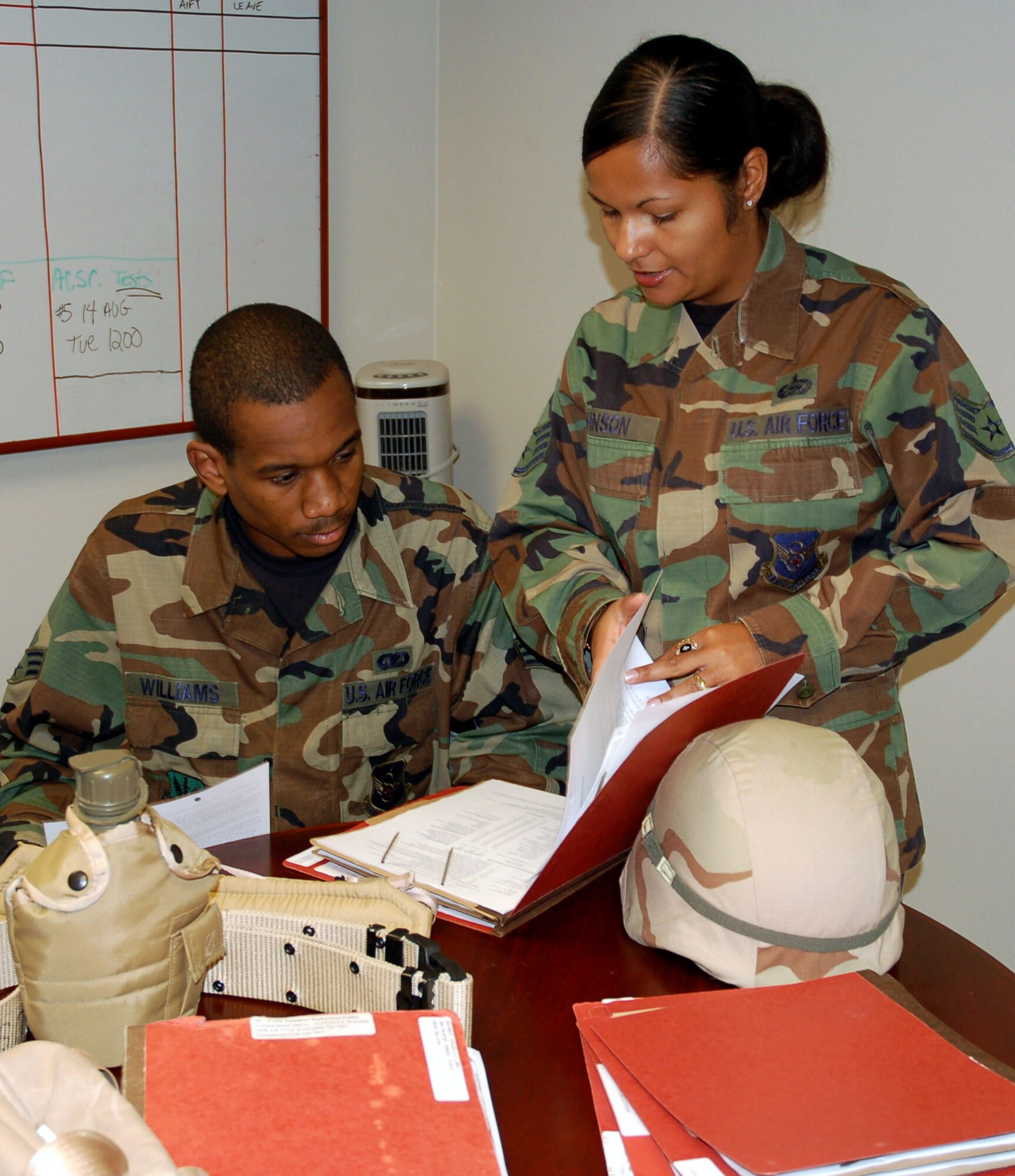 Staff Sgt. Brenda Johnson explains deployment requirements to Senior Airman Christopher Williams.Sergeant Johnson put her self aid and buddy care skills to work recently during a temporary duty by helping victims of a car accident. She is a unit deployment manager for Eighth Air Force. (U.S. Air Force photo/Tech. Sgt. Kristina Barrett)