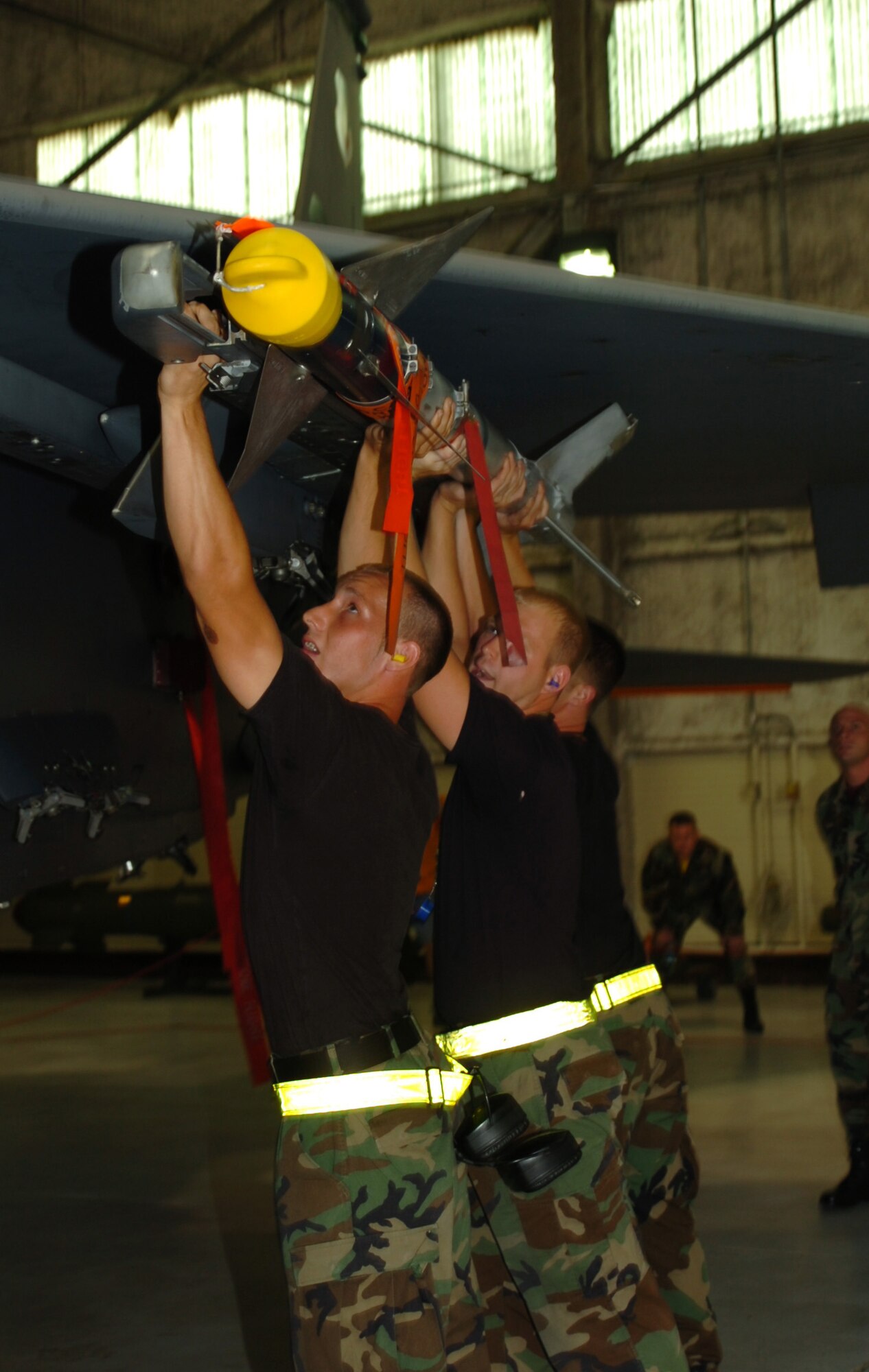 SEYMOUR JOHNSON AIR FORCE BASE, N.C. -  Airmen of the 336th Aircraft Maintenance Unit's weapons load crew, load a missle onto an F-15 Strike Eagle as part of the weapons load competition August 3. The weapons load crew competition is held quarterly for the 4th Aircraft Maintenance Squadron.

(US Air Force photo by Airman First Class Salma Din) 
