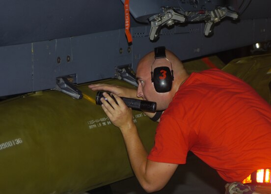 SEYMOUR JOHNSON AIR FORCE BASE, N.C. - An Airman from the 333rd Aircraft Maintenance Unit's weapons load crew looks into one of the many crevices on the F-15E to make sure all parts are securely in place on August 3, 2007. The weapons load crew competition is held quarterly on Seymour Johnson Air Force base.(US Air Force photo by Airmen First Class Ciara Wymbs)