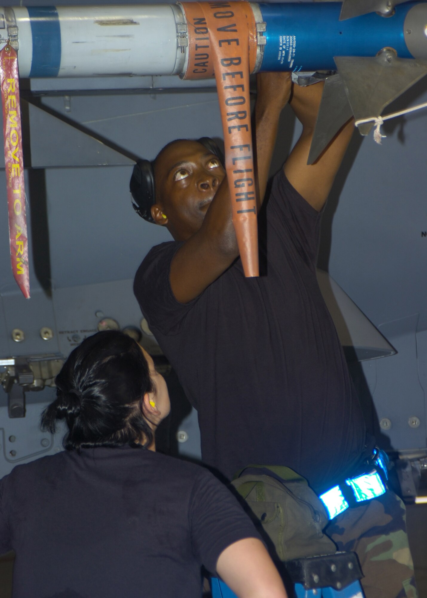 SEYMOUR JOHNSON AIR FORCE BASE, N.C. - Airmen from the 334th Aircraft Maintenance Unit's weapons load crew ensures a missle is secure on a F-15E Strike Eagle August 3. The  weapons load crew competition is held quarterly for the 4th aircraft maintenence unit on Seymour Johnson Air Force Base.(US Air Force photo by Airmen First Class Ciara Wymbs)
