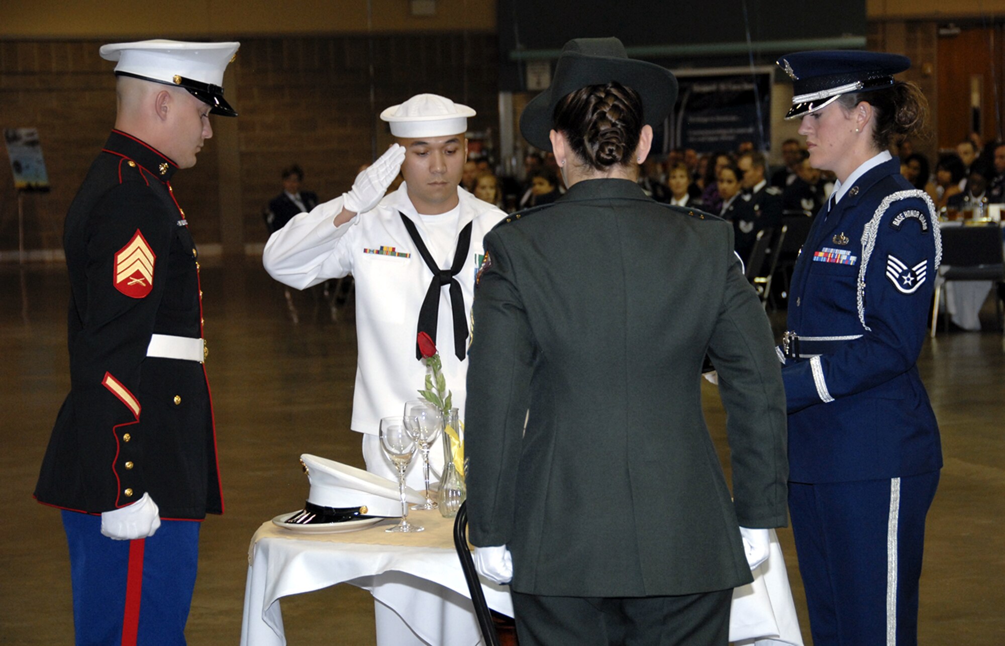 Army Staff Sgt. Kelly Smith, Marine Sgt. Jeremy May, Staff Sgt. Jessica Abarca and Navy Petty Office 2nd Class Dan Ocampo, members of the fallen heroes team, remember fallen servicemembers with a ceremony at the Senior NCO Induction Ceremony Aug. 3. (U.S. Air Force photo/Sandy Wassenmiller)
