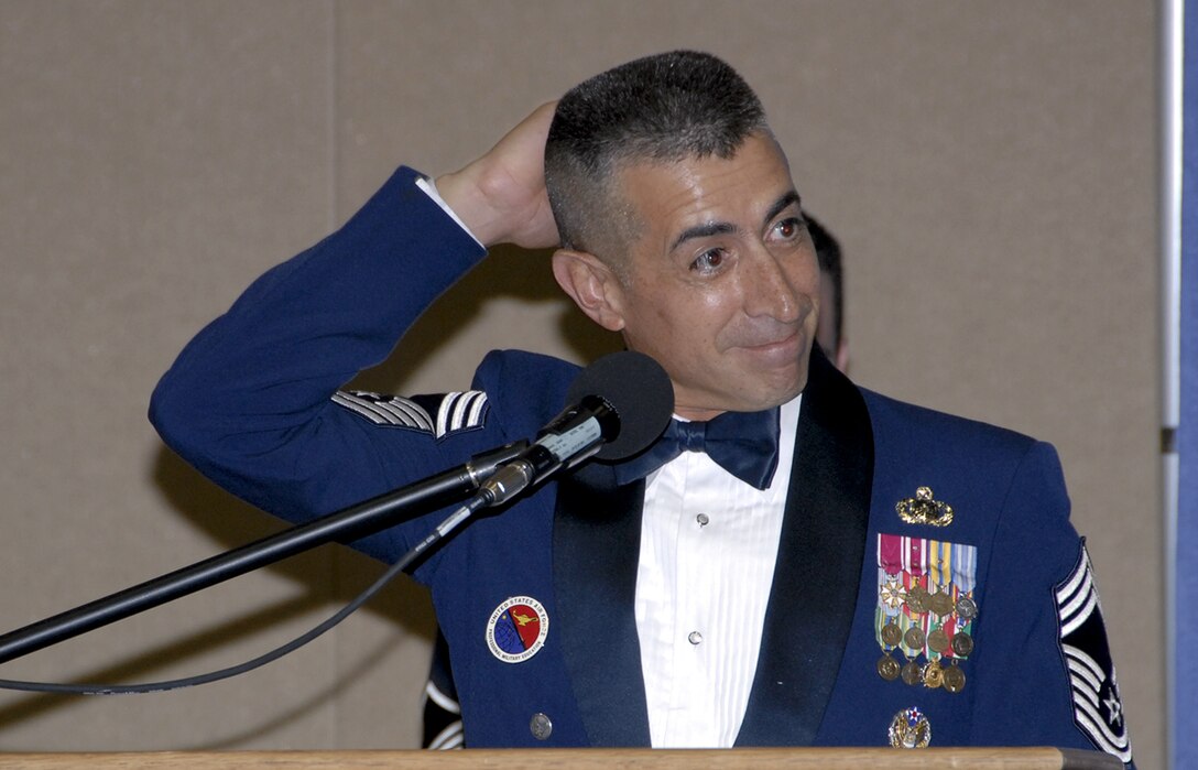 Chief Master Sgt. Larry Gonzales, Kirtland Air Force Base, N.M., NCO Academy commandant and guest speaker for the Senior NCO Induction Ceremony, speaks at the event Aug. 3. (U.S. Air Force photo/Sandy Wassenmiller)