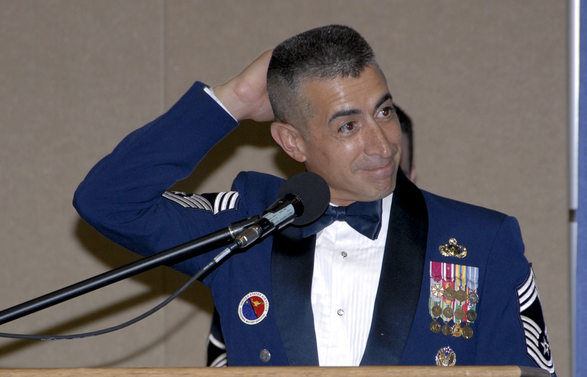 Chief Master Sgt. Larry Gonzales, Kirtland Air Force Base, N.M., NCO Academy commandant and guest speaker for the Senior NCO Induction Ceremony, speaks at the event Aug. 3. (U.S. Air Force photo/Sandy Wassenmiller)