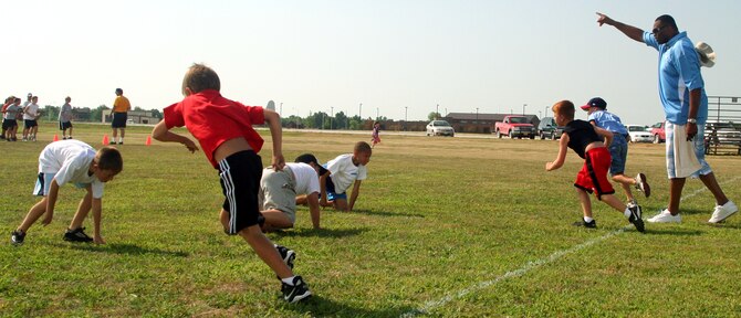 WHITEMAN AIR FORCE BASE, Mo. - Neil Smith supervises children drilling during the Aug. 8 youth football clinic at the base soccer field. He made the Pro Bowl 6 times during his career and led the National Football League with 15 sacks in the 1993 season. (U.S. Air Force photo/Airman 1st Class Stephen Linch)
