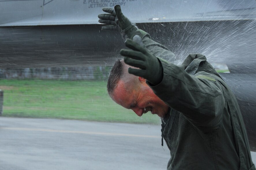 OSAN AIR BASE, Republic of Korea – Chief Master Sgt. Richard Jette, 51st Fighter Wing command chief, is sprayed with a water hose as part of the ceremony after his “fini flight” on Wednesday.  Fini flights are reserved for special occasions, and Chief Jette was given the special privilege for years of dedicated service to the Air Force as he prepares to retire.  Col. Jon A. Norman flew the F-16 Fighting Falcon for Chief Jette’s flight.  (U.S. Air Force photo by Airman First Class Chad Strohmeyer)
