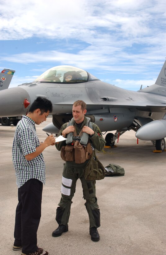 ANDERSEN AIR FORCE BASE, Guam - Capt. Ryan Wartman, 522d Expeditionary Fighter Squadron F-16 pilot, takes some time out to answer a few questions from Japanese media after he finished a Valiant Shield mission at Andersen Air Force Base, Guam. The Valiant Shield series of exercises focus on integrated joint training among U.S. military forces and enable real-world proficiency in sustaining joint forces and in detecting, locating, tracking and engaging units at sea, in the air, on land, and in cyberspace in response to a range of mission areas.
 (U.S. Air Force Photo by Master Sgt. Art Webb)