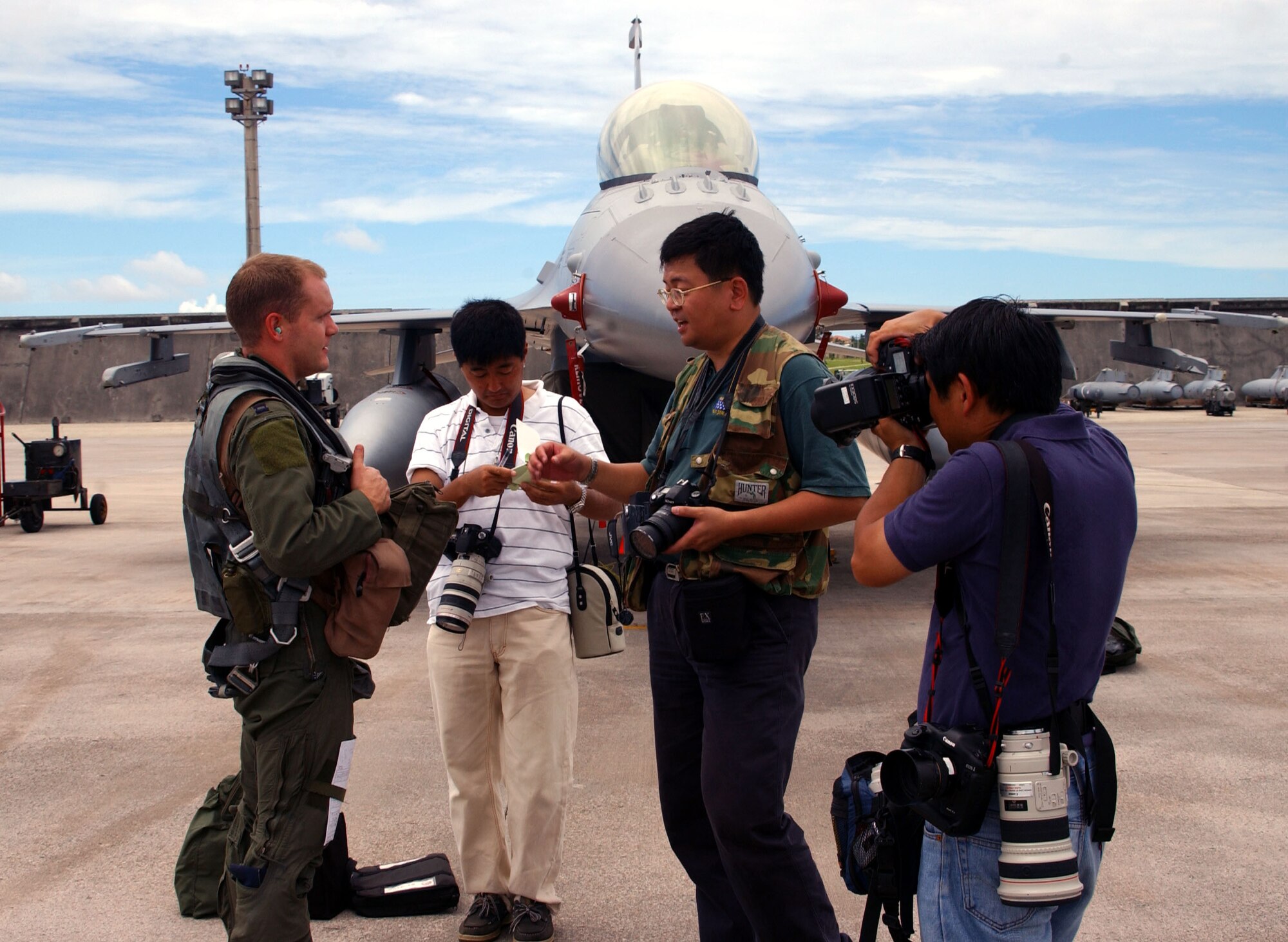 ANDERSEN AIR FORCE BASE, Guam - Capt. Jason Monaco, 522d Expeditionary Fighter Squadron F-16 pilot, talks to Japanese media after completing a flight during the latest Valiant Shield exercise held here.  The eight-day exercise tests the military’s ability to rapidly bring together joint forces in response to any regional contingency.  It also enables the United States to contribute to regional security and stability and demonstrates U.S. commitment in the Pacific.  (U.S. Air Force Photo by Master Sgt. Art Webb)