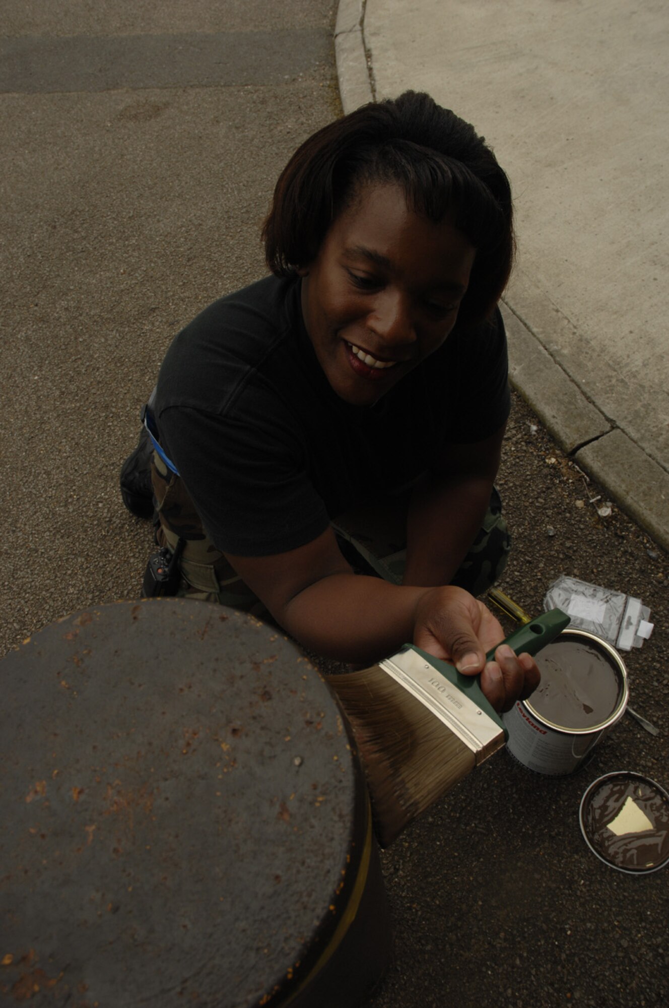 Staff Sgt Bobbie Workman, 48th Civil Engineering Squadron, RAF Lakenheath, repaints a bollard. Sergeant Workman, a Structural Craftsman, is capable of carpentry, masonry, metallurgy, welding, sheet metal, roofing and locksmith. (U.S. Air Force photo by Airman 1st Class Jessica Snow)