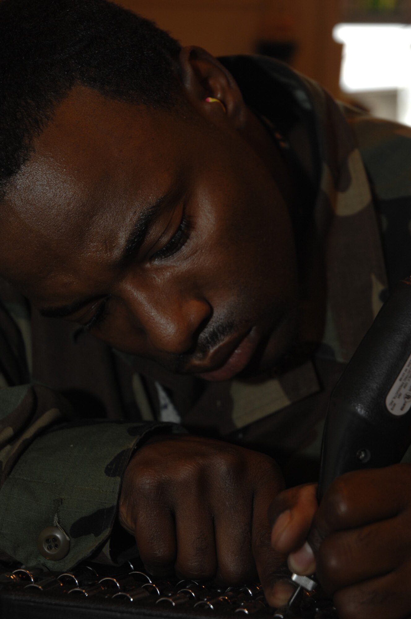Senior Airman Richard Miller, 48th Civil Engineering Squadron, RAF Lakenheath, engraves identification codes for tools that will be used on the flightline. Airman Miller, a Structural Craftsman, is capable of carpentry, masonry, metallurgy, welding, sheet metal, roofing and locksmith. (U.S. Air Force photo by Airman 1st Class Jessica Snow)