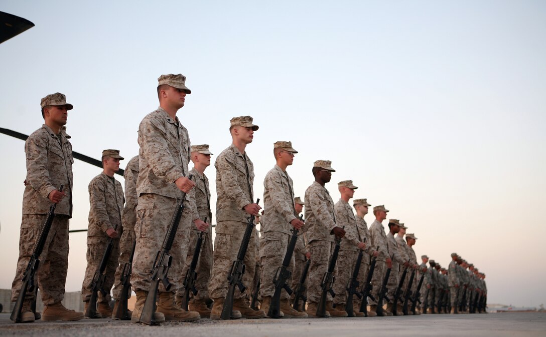 AL TAQADDUM, Iraq - Marines with Marine Medium Helicopter Squadron 262 and Soldiers from Task Force Dragon stand in formation during the transfer of authority ceremony, Aug. 10.