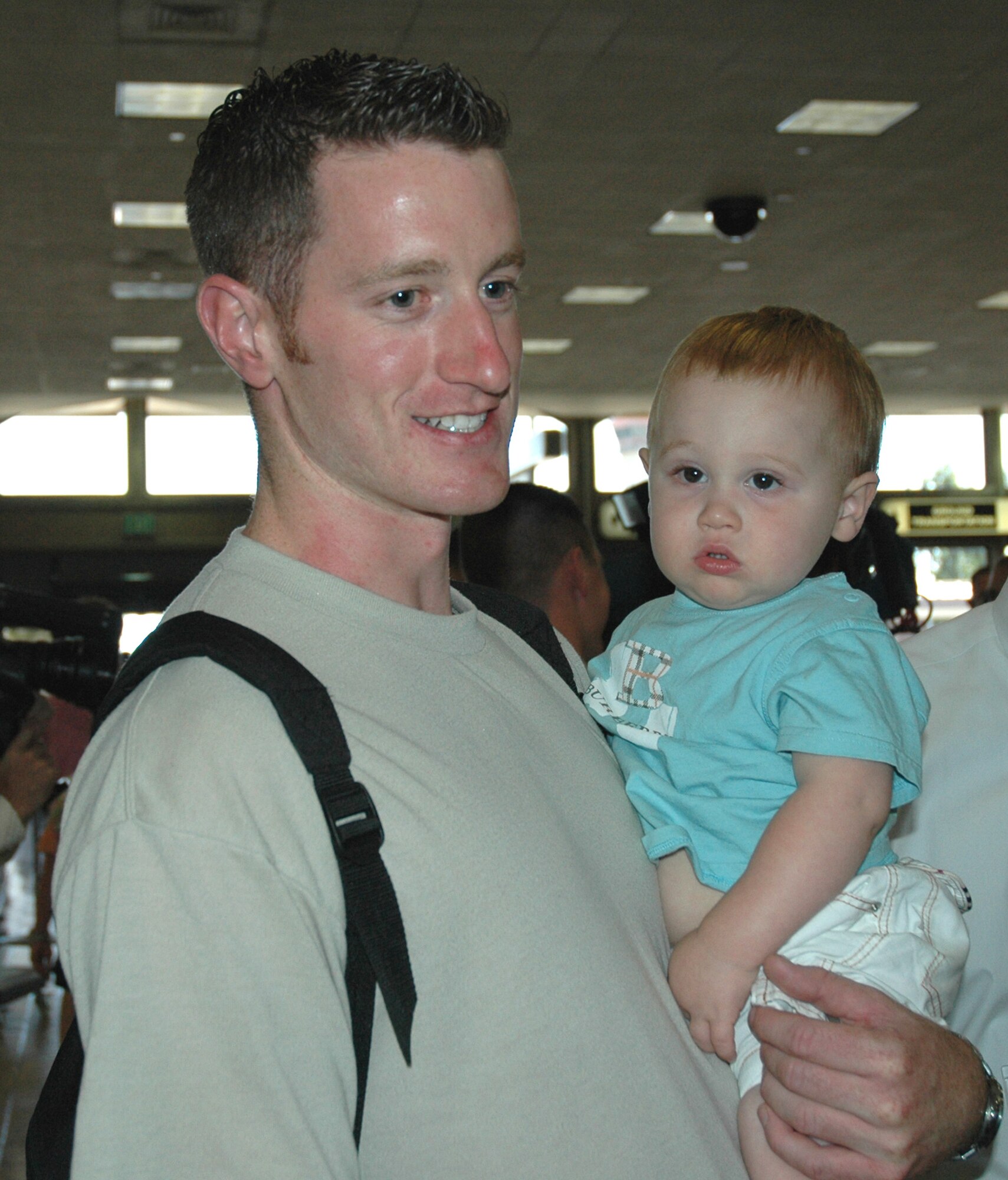 Staff Sgt. Patrick McCarthy, a Reservist with the 940th Logistics Readiness Squadron, Beale Air Force Base, Calif., holds his baby nephew whom he hasn't seen in six months. Sergeant McCarthy, just back from his second deployment in support of the Global War on Terror, volunteered at a local orphanage while stationed at Manas Air Base, Kyrgyzstan. (US Air Force photo/Master Sgt Ellen L Hatfield)