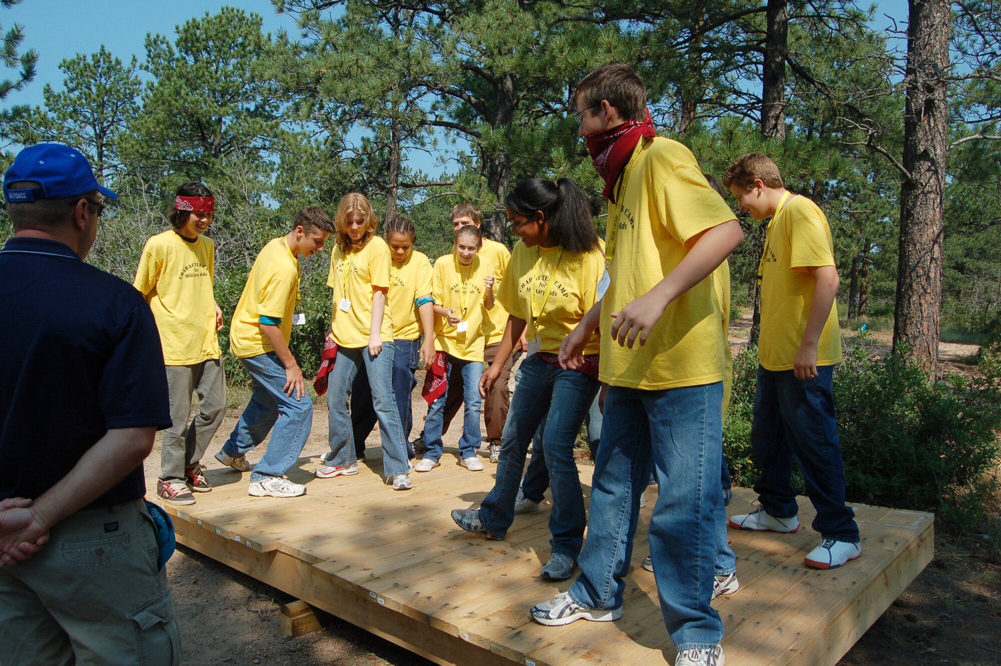 Kids attending the Operation Military Kids Character Camp work on balancing a teetering platform during a ropes course exercise at the Air Force Academy. Roughly 250 children of military members stationed in Colorado Springs attended the camp, which taught leadership and teamwork skills and was free for participants. (U.S. Air Force photo by Corey Dahl)