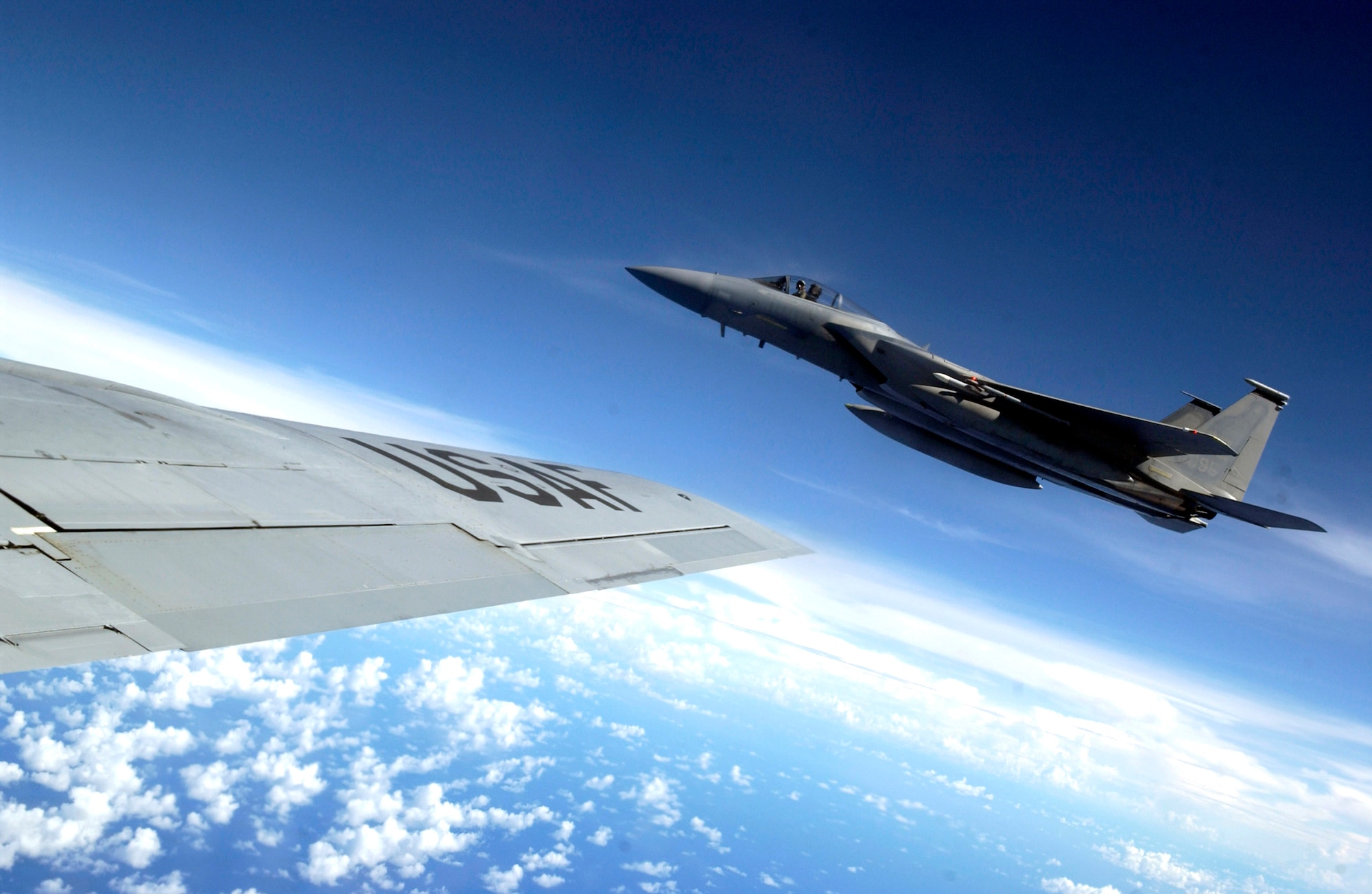 An F-15 Eagle flies alongside a KC-135 Stratotanker during Exercise Valiant Shield Aug. 9 at Andersen Air Force Base, Guam. The F-15 is from the 44th Fighter Squadron at Kadena Air Base, Japan, and the KC-135 is from the New Hampshire Air National Guard. During the exercise, Air Force aircraft and Airmen from stateside bases and Kadena AB will comprise part of an expeditionary air wing based at Andersen AFB. These forces will participate in integrated joint training with Navy and Coast Guard forces. (U.S. Air Force photo/Senior Airman Miranda Moorer) 
